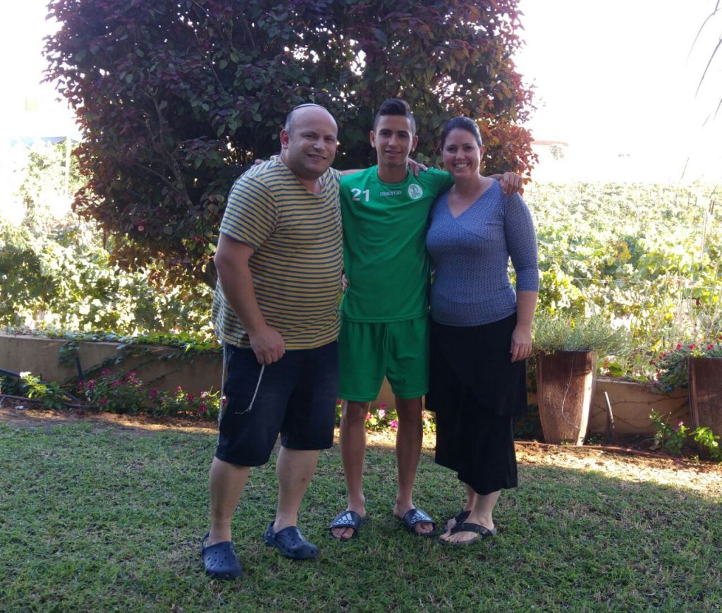 Shachar, a 16.5-year-old raising star in Kfar Saba's highest youth league, is flanked by his very supportive parents. (Facebook)