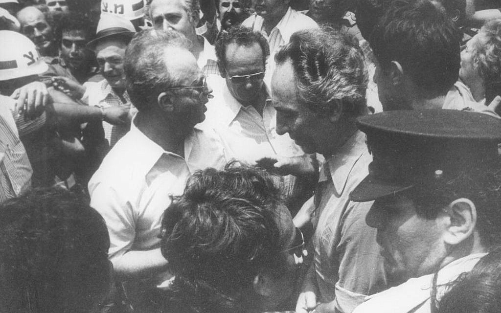 Defense Minister Shimon Peres (r) with Prime Minster Yitzhak Rabin welcoming the released Entebbe hostages upon their return to Israel on July 4, 1976. (Defense Ministry Archives)
