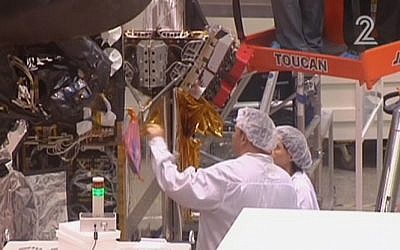 Workers for Israel Aerospace Industries building the Amos-6 satellite, in footage aired September 1, 2016. (screen capture: Channel 2)