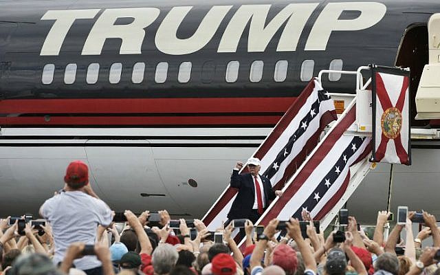 Republican presidential nominee Donald Trump acknowleges supporters before boarding his plane after a rally at the Lakeland Linder Regional Airport in Lakeland, Florida on October 12, 2016. (Mandel Ngan/AFP)