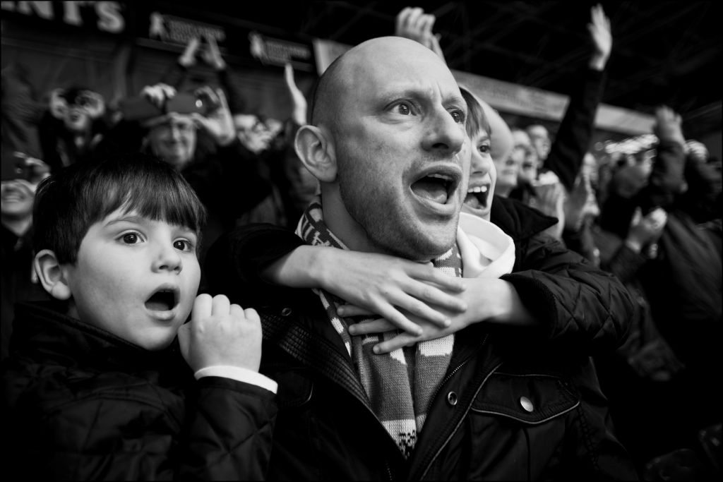 A Jewish man with his son at a football (soccer) game. (Judah Passow)