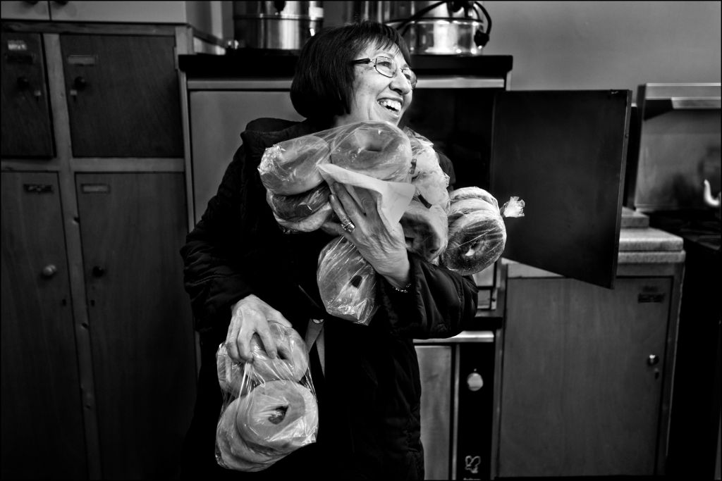 A woman carries all the bagels she can handle. (Judah Passow)
