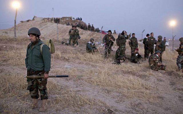 Kurdish Peshmerga forces gather prior to opening up a front against Islamic state in Nawaran, some 20 kilometers (13 miles) northeast of Mosul, Iraq, Thursday, Oct. 20, 2016. (AP Photo/Marko Drobnjakovic)