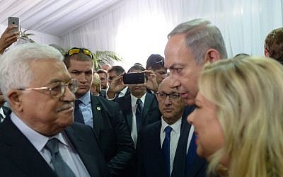 Prime Minister Benjamin Netanyahu and his wife Sara meet with Palestinian Authority President Mahmoud Abbas during the state funeral of late Israeli president Shimon Peres, at Mount Herzl in Jerusalem, September 30, 2016. (Amos Ben Gershom/GPO)