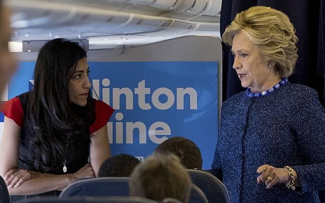 Then Democratic presidential candidate Hillary Clinton speaks with senior aide Huma Abedin aboard her campaign plane at Westchester County Airport, White Plains, October 28, 2016. (AP/Andrew Harnik)