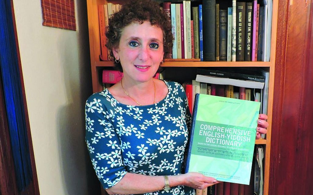 Gitl Schaechter-Viswanath holding her 'Comprehensive English-Yiddish Dictionary.' (The Jewish Standard)