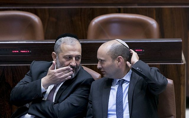 Interior Minister Aryeh Deri (L) speaks with Education Minister Nafatli Bennett at the Israeli parliament during the opening of the winter session in the assembly hall of the Knesset, Jerusalem, October 31, 2016. (Yonatan Sindel/Flash90 )