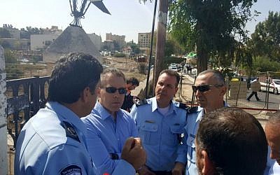 Public Security Minister Gilad Erdan speaks with Jerusalem Police chief Yoram Halevy at the scene of a terror attack near Ammunition Hill in Jerusalem on October 9, 2016. (Courtesy)