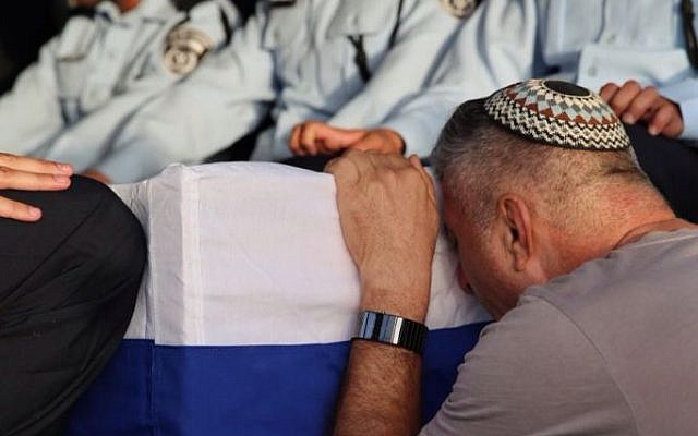 Uzi Kirma, father of First Sgt. Yosef Kirma, mourns alongside his son's coffin during the funeral on Jerusalem's Mount Herzl on October 9, 2016. Yosef Kirma, 29, was killed in a terror attack earlier that day. (Israel Police)