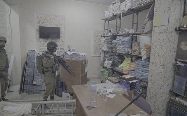 Soldiers inside a print shop which the IDF said produced posters and other material supporting terror attacks, in Al-Ram in the West Bank, October 19, 2016. (IDF Spokesperson)