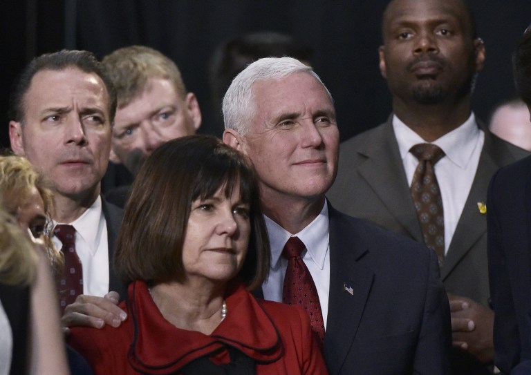 Republican vice presidential nominee Mike Pence and his wife Karen listen as his running mate Donald Trump addresses the final rally of his 2016 campaign at Devos Place in Grand Rapids, Michigan on November 7, 2016. (AFP PHOTO/MANDEL NGAN)