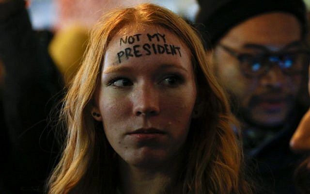 A woman looks on as she takes part in a protest against President-elect Donald Trump in front of Trump Tower in New York on November 10, 2016. (AFP/ KENA BETANCUR)