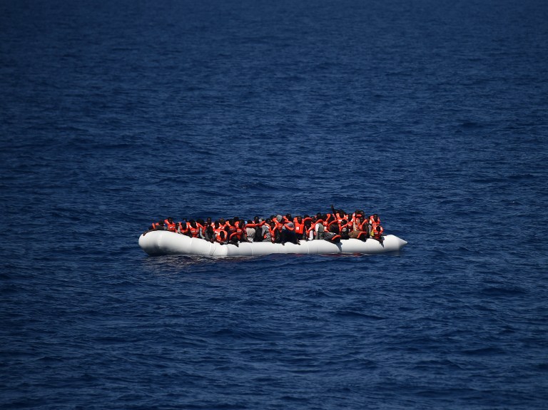 This file photo taken on May 24, 2016 shows refugees waiting on a rubber boat to be rescued during an operation at sea. (Doctors without Borders), on May 24, 2016. (AFP PHOTO / GABRIEL BOUYS)