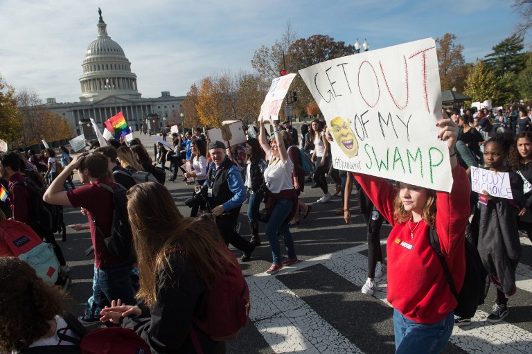High school students march past the US Capitol in Washington, DC, on November 15, 2016 as they protest the election of US President-elect Donald Trump. (AFP/NICHOLAS KAMM)