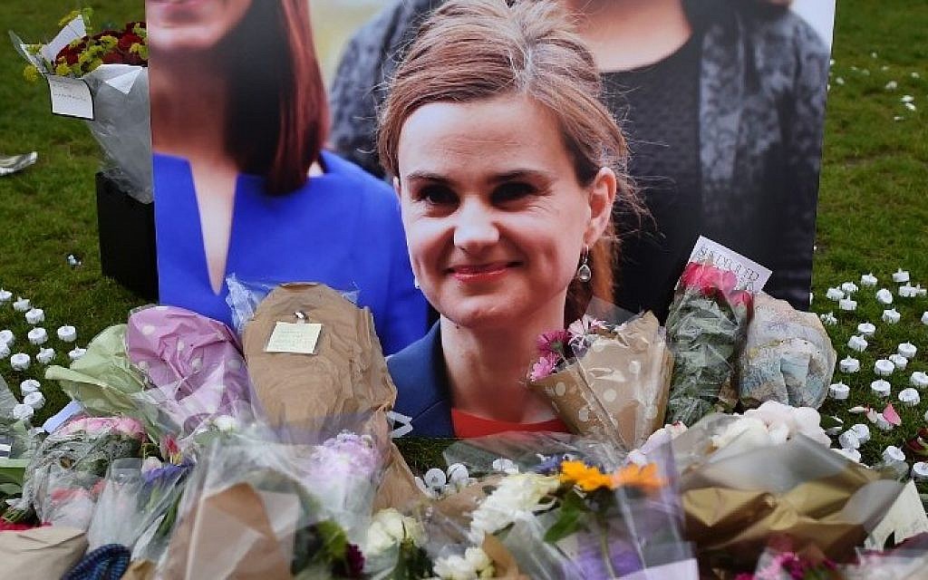 This photo taken on June 18, 2016 shows flowers and tributes laid in remembrance against a photograph of slain Labour MP Jo Cox in Parliament Square, central London, June 18, 2016. (AFP Photo/Ben Stansall)