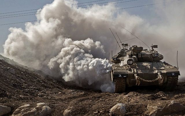 An IDF Merkava tank drives near the border with Syria on the Golan Heights, on November 28, 2016. (AFP PHOTO/JACK GUEZ)