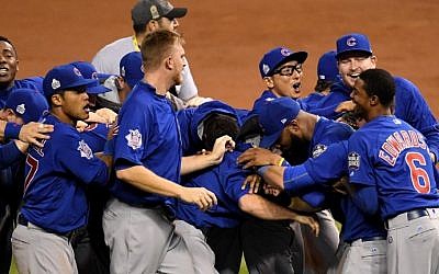 The Chicago Cubs celebrate after defeating the Cleveland Indians 8-7 in Game Seven of the 2016 World Series at Progressive Field on November 2, 2016 in Cleveland, Ohio. (Jason Miller/Getty Images/AFP)