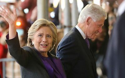 Hillary Clinton, holding hands with her husband, former President Bill Clinton, waves to a crowd outside a New York hotel as she arrives to speak to her staff and supporters after losing the race for the White House, Wednesday, Nov. 9, 2016. (AP Photo/Seth Wenig)