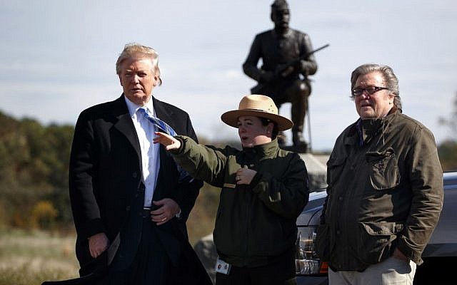 Interpretive park ranger Caitlin Kostic, center, gives a tour near the high-water mark of the Confederacy at Gettysburg National Military Park to then Republican presidential candidate Donald Trump, left, and then campaign CEO Steve Bannon, October 22, 2016, in Gettysburg, PA. (AP Photo/ Evan Vucci)