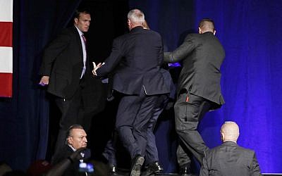 Secret Service agents pull Republican presidential candidate Donald Trump of the stage at a rally Saturday, Nov. 5, 2016, in Reno, Nev. (AP Photo/John Locher)