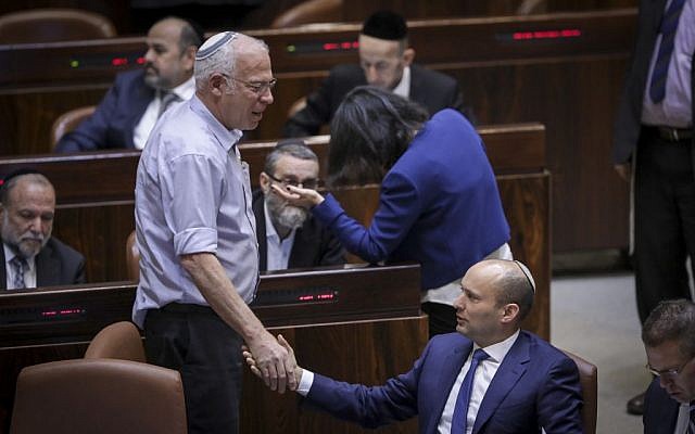 Jewish Home leader Naftali Bennett (sitting) with Jewish Home MK Uri Ariel during a plenum session on the so-called Regulation Bill, November 16, 2016. (Yonatan Sindel/Flash90)