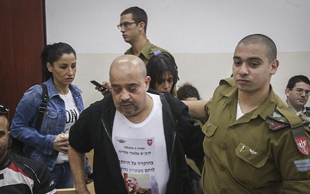 Elior Azaria seen with his father, left, during a court hearing at a military court in Jaffa, November 23, 2016. (Flash90)