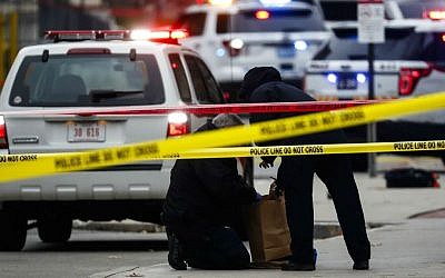 Crime scene investigators collect evidence from the pavement as police respond to an attack on campus at Ohio State University, Monday, Nov. 28, 2016, in Columbus, Ohio. (AP Photo/John Minchillo)