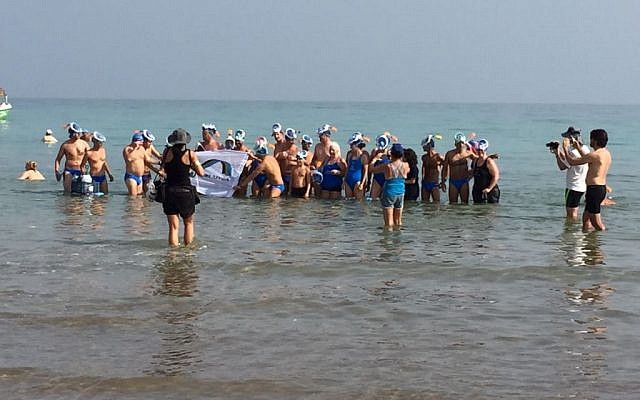 Group of swimmers who attempted a seven-hour swim across the Dead Sea in from Jordan to Israel a bid to draw attention to its environmental degradation pose for a photograph on November 15, 2016. (EcoPeace Middle East)