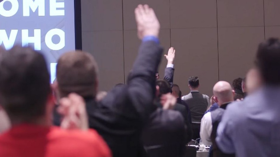 Attendants at the National Policy Institute's annual conference give Nazi salutes as NPI head Richard Spencer speaks of white supremacy, on November 19, 2016 (YouTube screenshot)