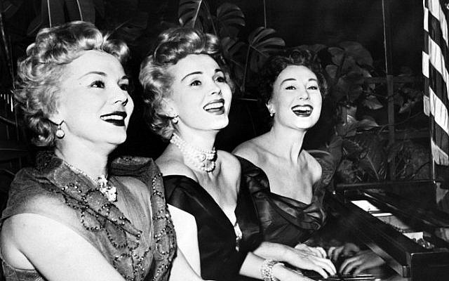 This file photo from January 1954 shows US actress Zsa Zsa Gabor, center, and her sisters Eva , left, and Magda, playing piano for new year day. (AFP)