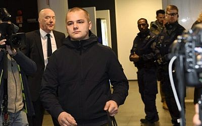 Picture taken on December 21, 2016 shows Jesse Torniainen (C), a member of the Finnish neo-Nazi group Finnish Resistance Movement (FRM), during his trial at the District Court in Helsinki, Finland. (AFP/Lehtikuva/Vesa Moilanen)