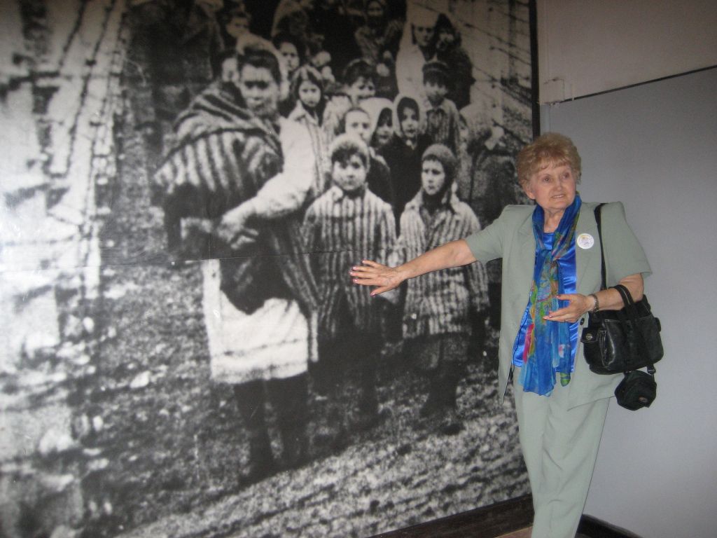 Mengele twin Eva Mozes Kor points herself out in an image in the Auschwitz Memorial Museum during a 2007 trip. (courtesy)