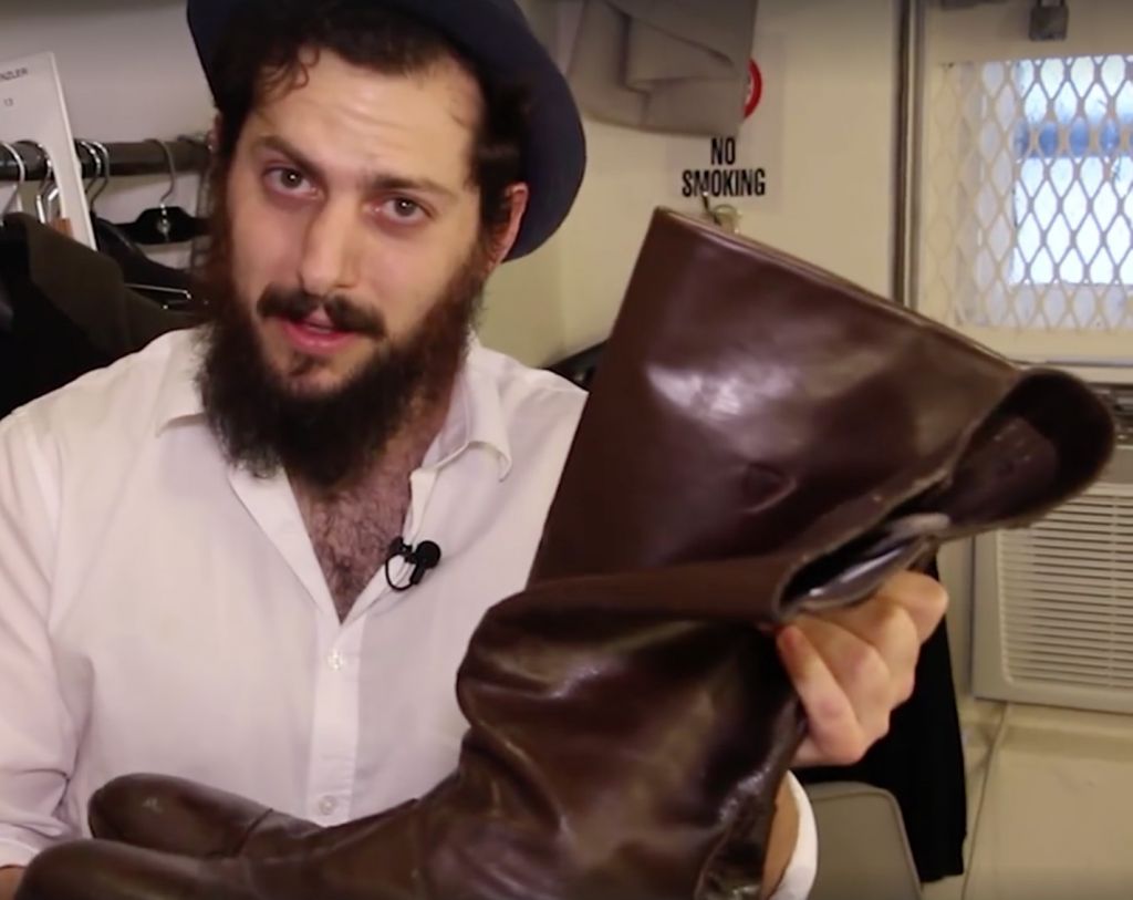 Michael Bernardi with his father Herschel's leather boots, worn while playing Tevye in a Broadway production of 'Fiddler on the Roof.' (screenshot)