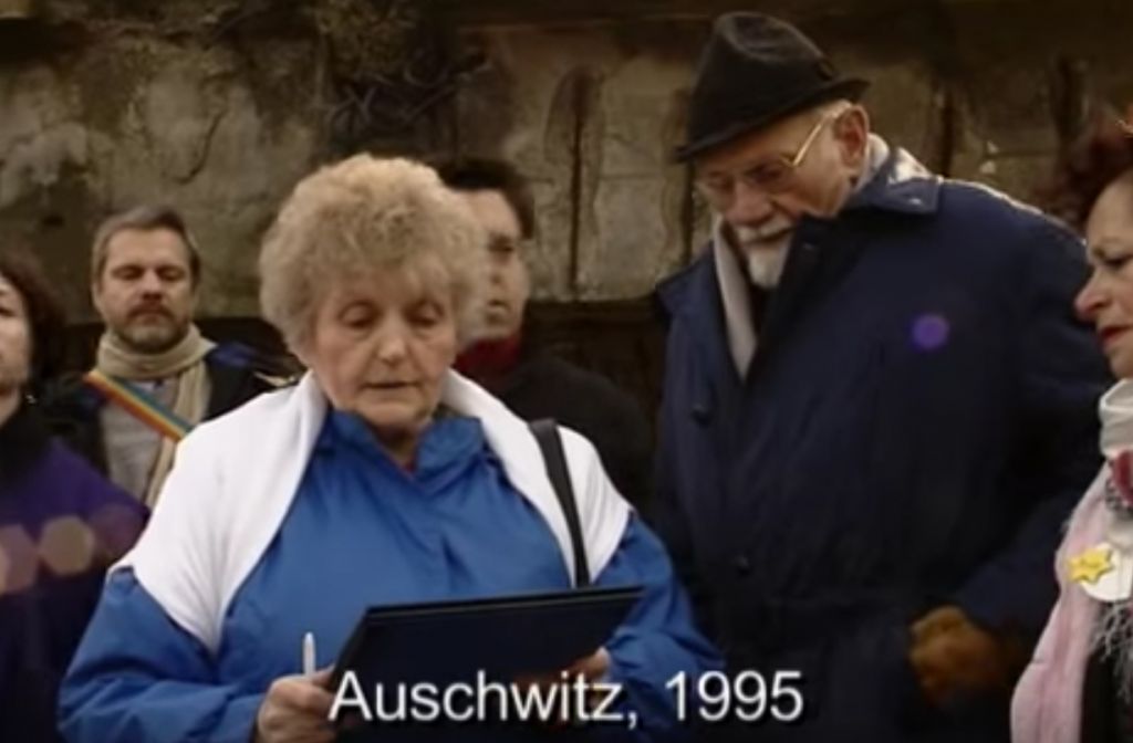Mengele twin Eva Mozes Kor at Auschwitz on January 27, 1995, reading her letter of forgiveness to Nazi Dr. Hans Munch. (Youtube screenshot)