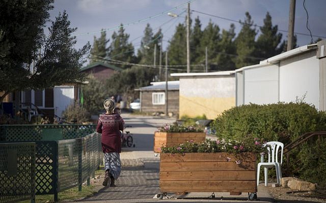Jewish residents of the unauthorized Israeli outpost of Amona, in the West Bank, seen walking on the streets of the settlement on November 17, 2016. (Miriam Alster/Flash90)