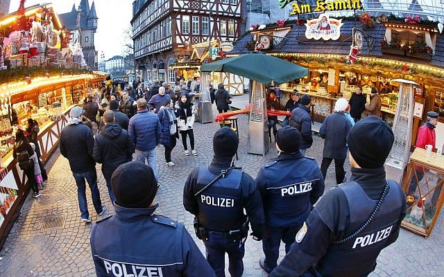 German police officers patrol the Christmas market in Frankfurt, Germany, Tuesday, Dec. 20, 2016. (AP Photo/Michael Probst)