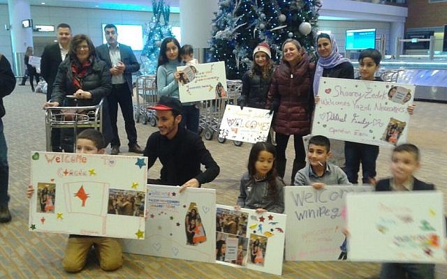 Two Yazidi families being greeted by local volunteers after a privately sponsored mission called Operation Ezra brought  them to Winnipeg, Manitoba on December 20, 2016 (Nafiya Naso)