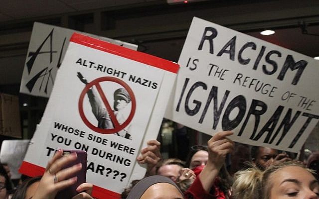Protesters hold up signs at a demonstration againt Richard Spencer, a leader of the so-called alt-right movement, at Texas A&M University on December 6, 2016. (Ricky Ben-David/Times of Israel)