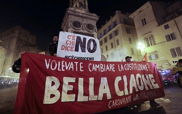 Anti-referendum militants gather in downtown Rome after Italian Premier Matteo Renzi conceded defeat in a constitutional referendum and announced he will resign in Rome, early Monday, Dec. 5, 2016. Banner in Italian reads "You wanted to change the Constitution? Goodby Bella". (AP/Gregorio Borgia)