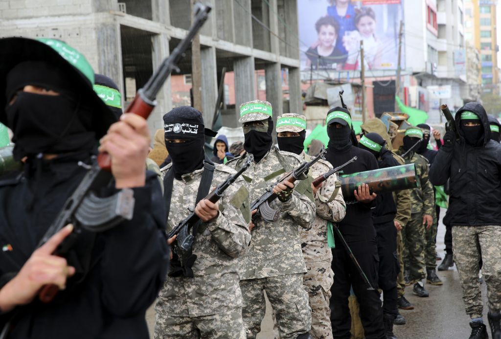 Masked Palestinian gunmen from the Izzedine al-Qassam Brigades, a military wing of Hamas, commemorate the 29th anniversary of their group, in Gaza City, Wednesday, Dec. 14, 2016. (AP Photo/Adel Hana)