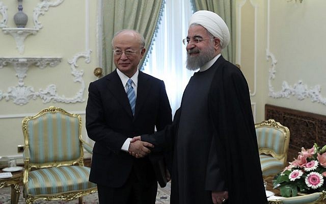 President Hassan Rouhani (r) and Director General of the International Atomic Energy Agency, IAEA, Yukiya Amano shake hands ahead of their meeting at the Presidency office in Tehran, Iran, on December 18, 2016. (Iranian Presidency Office/AP)