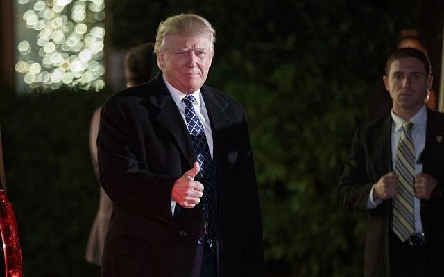 President-elect Donald Trump gestures toward reporters as he arrives for a party at the home of Robert Mercer, one of his biggest campaign donors, December 3, 2016, in Head of the Harbor, N.Y. (AP Photo/Evan Vucci)