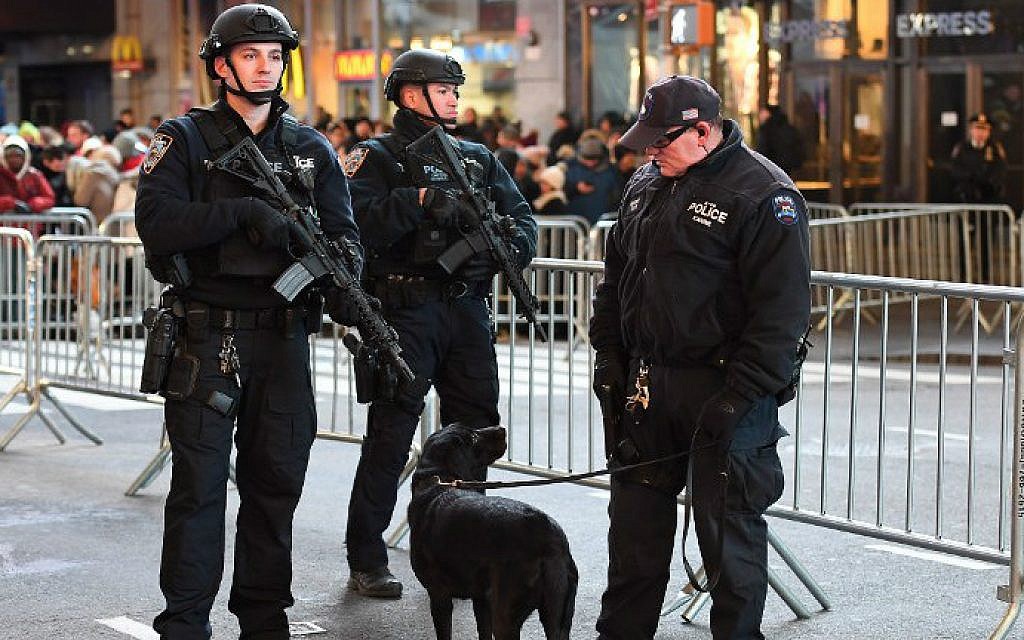 New York City police officers stand guard in Times Square on December 31, 2016. (Angela Weiss/AFP)