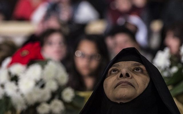 A nun attends Christmas mass led by Egyptian Coptic leader Pope Tawadros II at the St. Mark's Coptic Orthodox Cathedral in the Abbassia District of Cairo on January 6, 2017. (AFP PHOTO / KHALED DESOUKI)