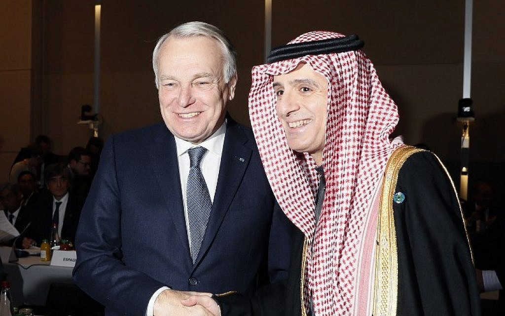 French Minister of Foreign Affairs Jean-Marc Ayrault (L)  shakes hands with Saudi Foreign Minister Adel al-Jubeir during the opening of the Mideast peace conference in Paris on January 15, 2017. (AFP PHOTO / POOL / THOMAS SAMSON)
