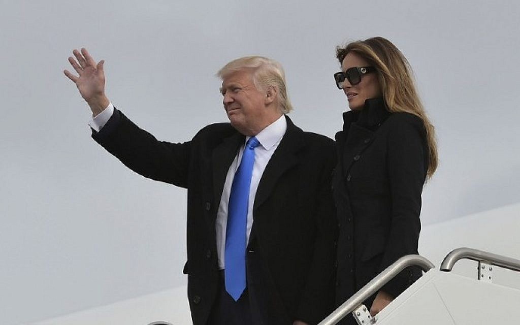 US President-elect Donald Trump and his wife Melania step off a plane upon arrival at Andrews Air Force Base in Maryland on January 19, 2017.  (AFP PHOTO / MANDEL NGAN)