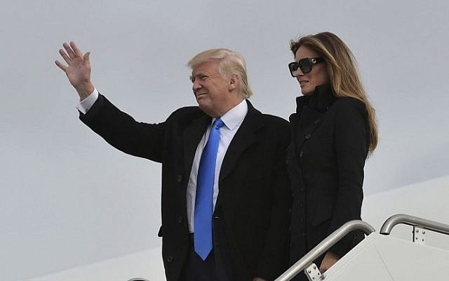 Donald Trump and his wife Melania step off a plane upon arrival at Andrews Air Force Base in Maryland on January 19, 2017. (AFP Photo/Mandel Ngan)