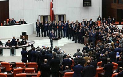 Turkey's Prime Minister Binali Yildirim, center, is applauded by some of his lawmakers after Turkey's parliament approved a contentious constitutional reform package, paving the way for a referendum on a presidential system that would greatly expand the powers of President Recep Tayyip Erdogan's office, on January 21, 2017 in Ankara. (Adem Altan/AFP)