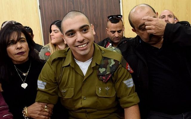 IDF soldier Elor Azaria, who was convicted of manslaughter for shooting dead a prone and wounded Palestinian assailant, in a case that has deeply divided Israel, sits with his parents as he waits for his sentence hearing at a military court in Tel Aviv January 24, 2017. (AFP/Debbie Hill)