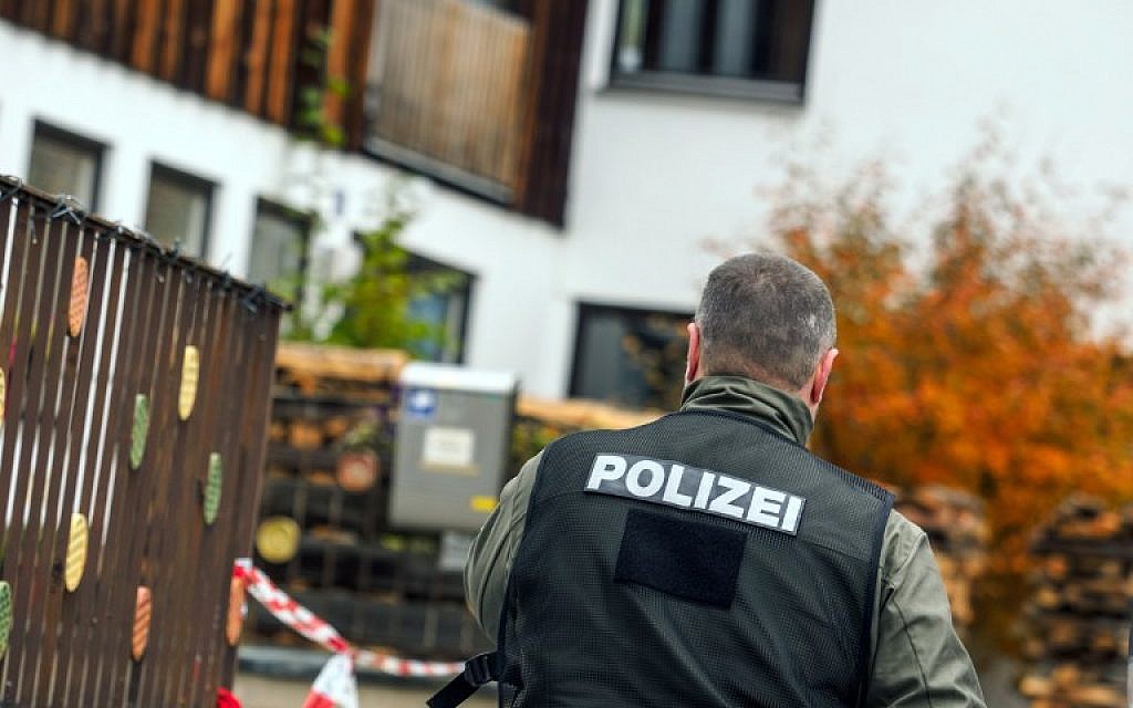 This photo taken on October 19, 2016 shows a policeman pictured in Georgensgmuend, southern Germany, in front of a house of a member of the so-called Reichsbuerger movement. (AFP/dpa/Nicolas Armer)